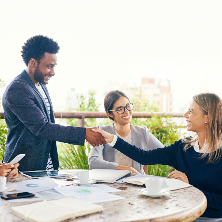 shot-of-businesspeople-shaking-hands-during-a-meet-2023-11-27-05-01-04-utc (1)